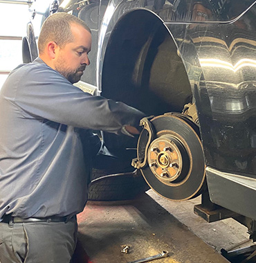 auto mechanic completes brake job